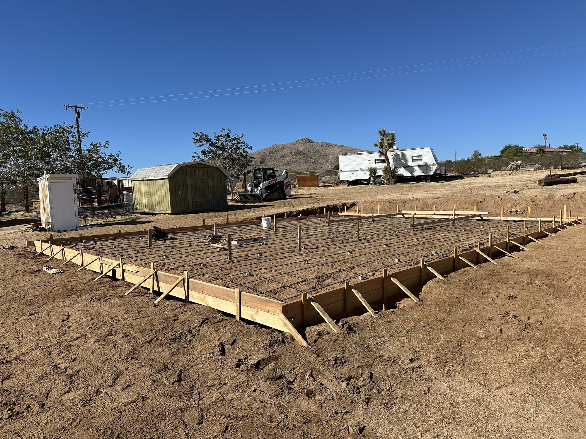 Slab perimeter formed and staked on a graded, compacted pad
